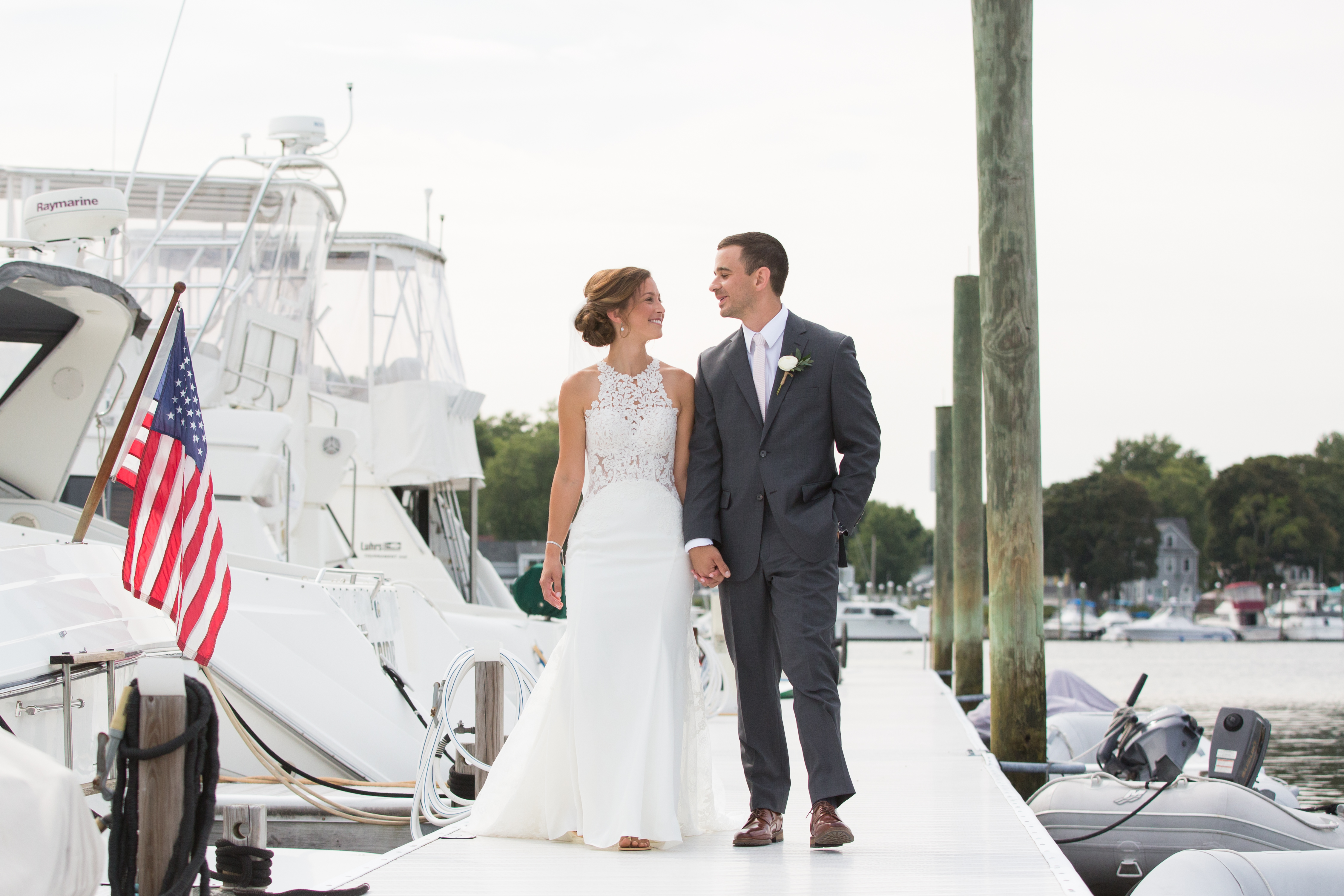 A bride and groom share an intimate first look on the docks of Harbor Lights in Warwick Rhode Island.