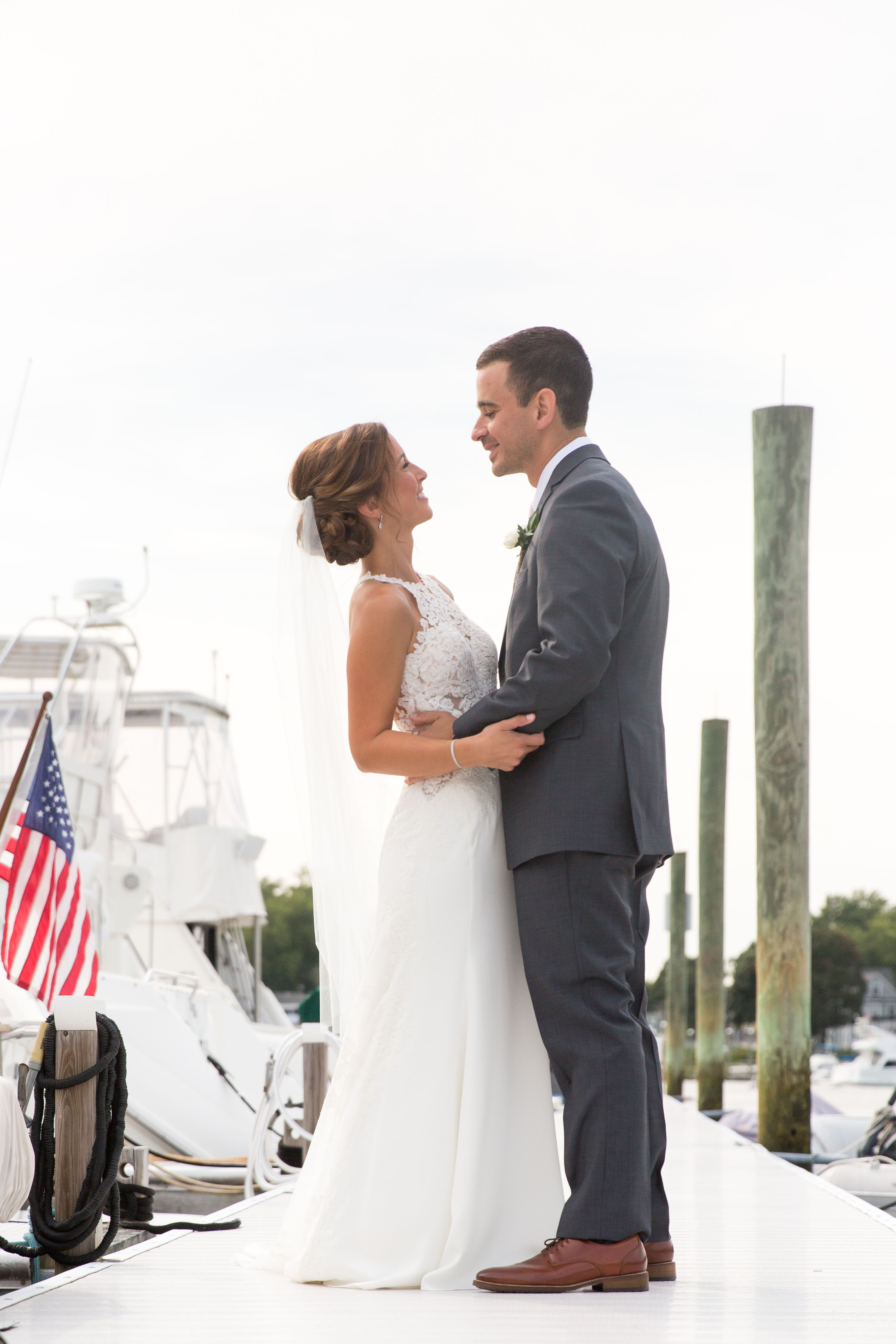 Bride and groom pause together on the docks at Rhode Island wedding venue, Harbor Lights.