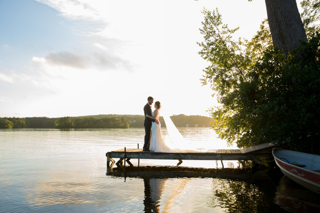 Photo of a bride and groom on the dock at Lake Pearl Wrentham.