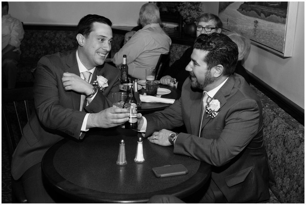 Groom toasting a glass on his wedding day.