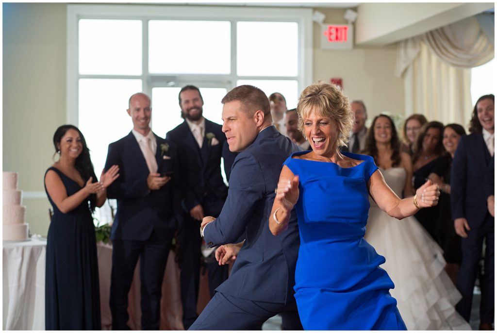Groom dances with his mom during the mother son dance. 