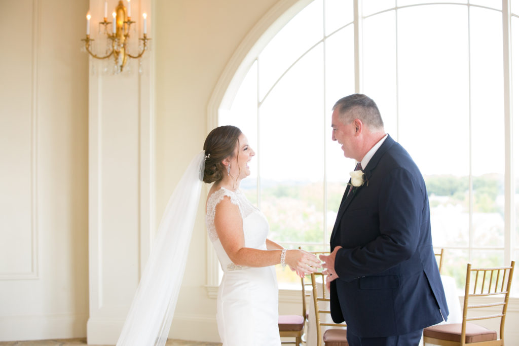 A bride shares a first look with her father at Granite Links Golf Club.